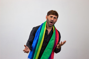 Portrait of handsome young man with gay pride movement LGBT Rainbow flag and brown hair with love, looking at the camera. Isolated on white background.