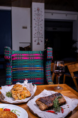 Different meat and a glass of wine in the interior of the restaurant