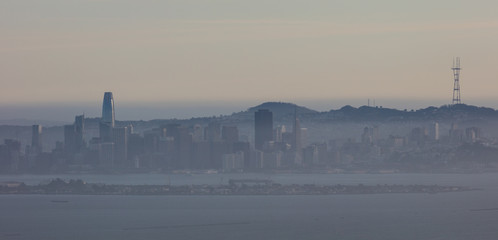 The northern California city of San Francisco skyline is seen through poor air quality at dusk.
