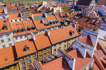 Fototapeta na wymiar Warsaw, Poland red orange roof in old town market square with historic street town architecture and windows rooftop closeup pattern
