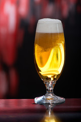 Glass of beer on the dark background