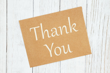 Thank you text on a brown greeting card