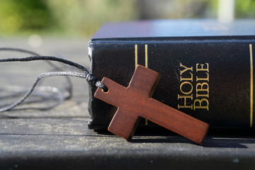 Holy Bible book with wooden cross