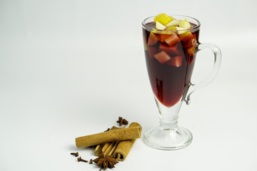 Mulled wine with orange, cinnamon sticks, anise isolated on white background.
