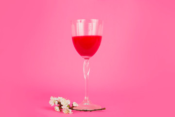 Fresh delicious cherry drink with flowers. Red cocktail with cherry. Refreshing summer drink red