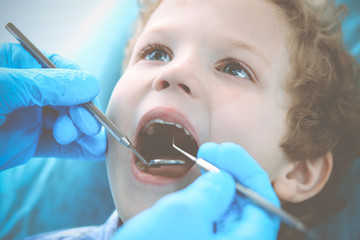 Doctor and patient child. Boy having his teeth examined with dentist. Medicine, health care and stomatology concept