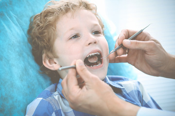 Doctor and patient child. Boy having his teeth examined with dentist. Medicine, health care and stomatology concept