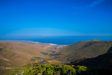 Spain, Lanzarote, Huge valley with view to coast and ocean from mountain top near haria town