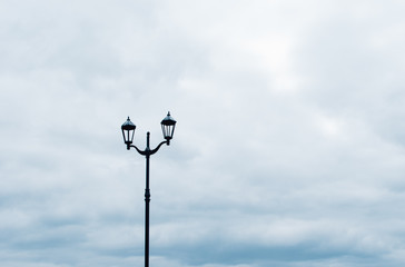Fototapeta na wymiar Street lamp against a cloudy sky.