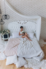 A bride in a white dress is holding a beautiful wedding bouquet.