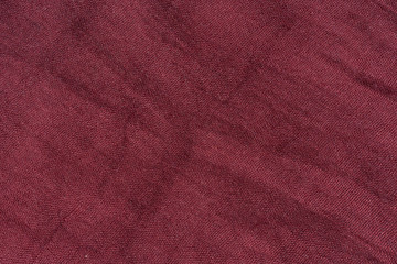 Texture of dark pink fabric. The texture of the fabric color Marsala. Burgundy scarf close-up....