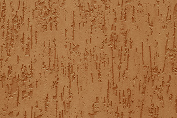 Abstract pattern with embossed from yellow stucco on a concrete wall. Surface of grooved orange wall. Texture of light brown parget