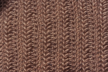 Brown texture knitted wool fabric. Cappuccino knitted abstract background. Light brown wool for knitting.