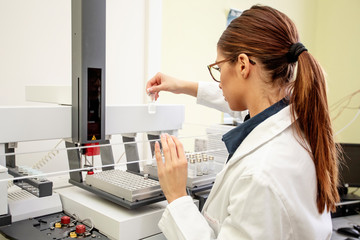 Working on chromatography with liquid woman in laboratory