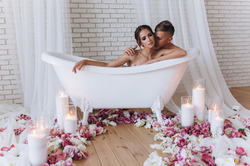 The loving pleasures of a young married couple in the bathroom.