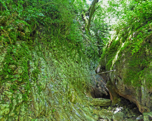 Fototapeta na wymiar Small canyon between aged rocks.