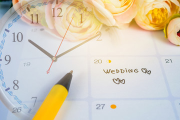 Word Wedding to Reminder Wedding day in calendar planning and pen with heart.