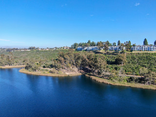 Fototapeta premium Aerial view of Miramar reservoir in the Scripps Miramar Ranch community, San Diego, California. Miramar lake, popular activities recreation site including boating, fishing, picnic & 5-mile-long trail.