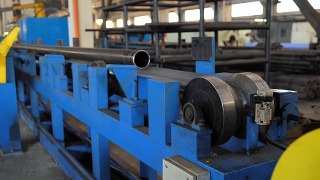 Rolling forming rolls metal works on manufacture of pipes. Rolling mill machine for rolling steel sheet. Rolling mill machine with cooling water