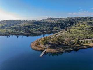 Fototapeta premium Aerial view of Miramar reservoir in the Scripps Miramar Ranch community, San Diego, California. Miramar lake, popular activities recreation site including boating, fishing, picnic & 5-mile-long trail.