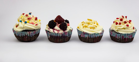 muffin. chocolate muffin, chocolate muffin with cream and berries, four muffins on a white background. space for text