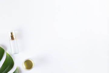 Moisturizing care skincare face cream for healing complicated troubled skin type in an open jar with visible texture. Copy space, close up, background, flat lay, top view. Monstera leaf decoration.