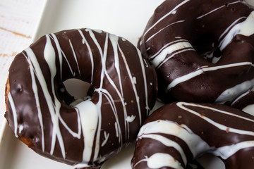 donut, donut classic, donut according to an old recipe, Ukrainian donuts. Chocolate donuts. White glass copis.