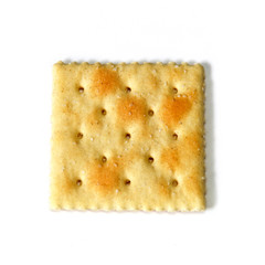 Looking down at one saltine, also known as soda and soup crackers, over white, not isolated.