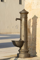 Typical drinking fountain in the south of Italy, the city of Santa Maria di Leuca, Salento, Apulia, drinking water in the street