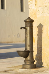 Typical drinking fountain in the south of Italy, the city of Santa Maria di Leuca, Salento, Apulia, drinking water in the street
