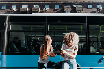 Beautiful women using a mobile in the Street.