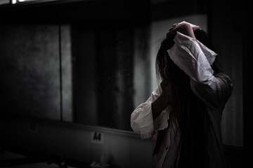 Portrait of asian woman make up ghost face with blood,Horror scene,Scary background,Halloween...