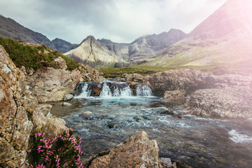 Fototapeta na wymiar Beautiful waterfalls scenery on the Isle of Skye, Scotland: The Fairy Pools, Glen Brittle, Scotland. Sunshine.