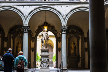 Tourists looking at David by Michelangelo in Galleria dell'Accademia in Florence. Italy