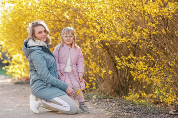 Fototapeta premium Mother and little daughter playing together in a park