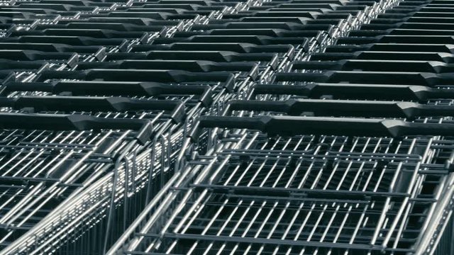 Consumerism supermarket carts waiting buyers in many rows, parallax effect