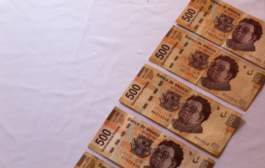 top view mexican pesos with white background (bills of different denominations)
