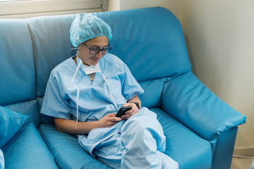 Beautiful female doctor using mobile phone at hospital