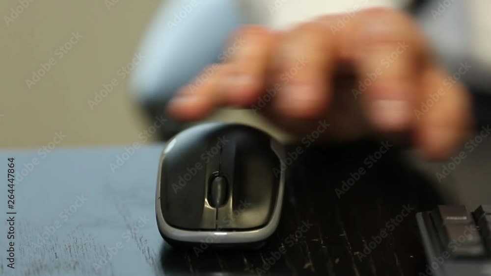 Poster Man placing hand on mouse then typing on keyboard in office scene