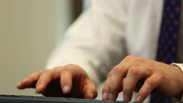 Man typing begins to struggle with what to write down using keyboard
