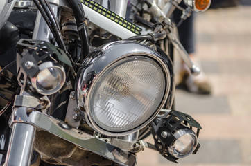 chrome shiny chopper motorcycle headlight close up