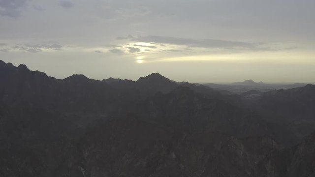 Adventure vibes, sunset and endless mountains in sight. Aerial view.