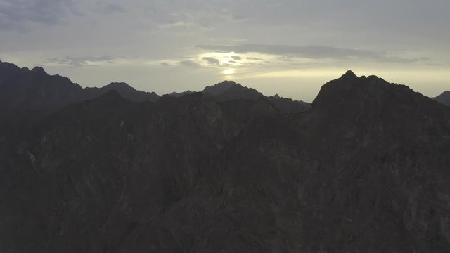 Sunset and endless mountains in sight. Aerial view.