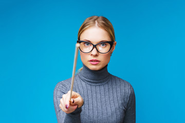 Portrait of female teacher with pointer pointing forward