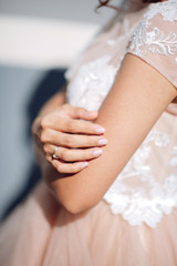 Young woman posing in a white wedding dress close up