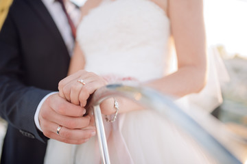 Bride and groom in a wedding dress posing on a yacht