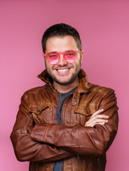 Image of happy brunet in pink glasses and leather jacket