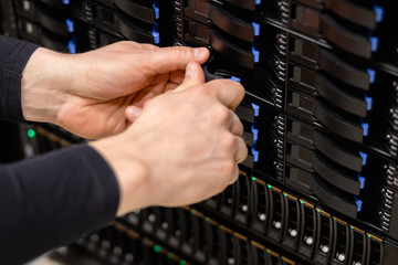 Naklejka premium IT Professional Replacing Server Drive In Fiber San Storage