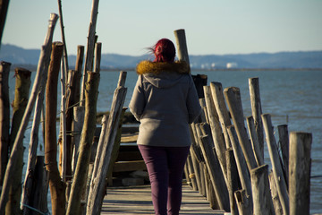Red-head on a stilts pier