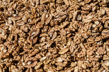 Large group of fresh walnut kernels sold at a spice food market, organic food background
